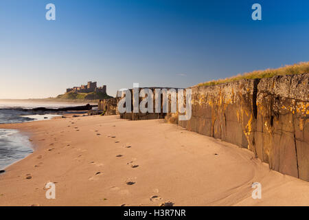 Bamburgh Castle with Rocks. Bamburgh Castle viewed from the beach with rock in the foreground Stock Photo