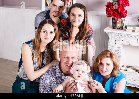 Big happy family sitting on couch Stock Photo