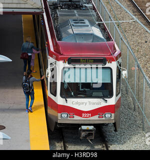 Commuters board a C-Train on the Calgary Transit light rail transit system Stock Photo