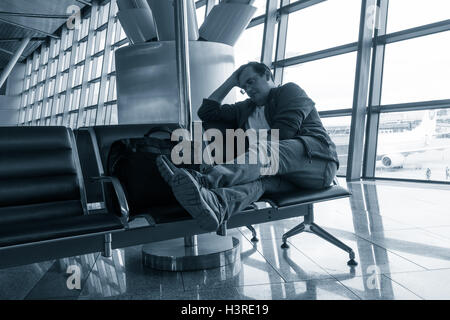 Man sleeping in the airport Stock Photo