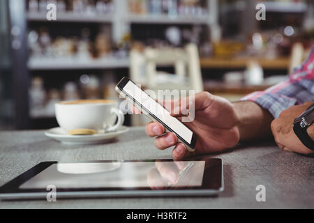 Hand of man holding mobile phone Stock Photo