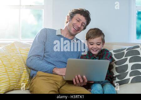 Father and son using laptop Stock Photo
