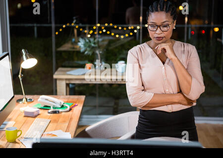 Businesswoman looking at computer screen Stock Photo