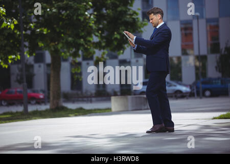 Handsome businessman using digital tablet Stock Photo