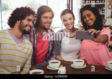 Group of friends taking a selfie while having cup of coffee Stock Photo
