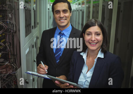 Portrait of technicians analyzing server Stock Photo