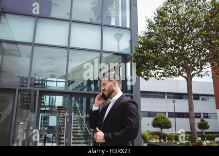 Businessman text messaging on mobile phone Stock Photo