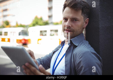 Handsome business executive using digital tablet Stock Photo