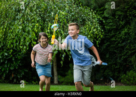 Kids playing with bubbles in the park Stock Photo