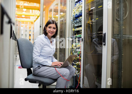 Technician working on laptop Stock Photo