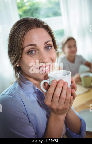 Smiling woman having coffee Stock Photo