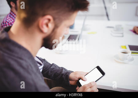 Executive using mobile phone in meeting at creative office Stock Photo