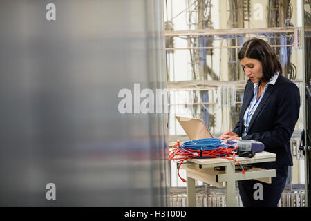 Technician working on laptop Stock Photo
