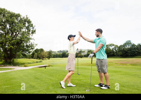 Couple giving high five to each other Stock Photo