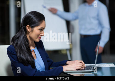 Portrait of businesswoman working on laptop Stock Photo