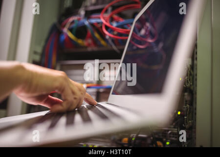 Technician working on laptop Stock Photo