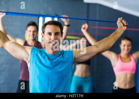 Male instructor with athletes in fitness studio Stock Photo