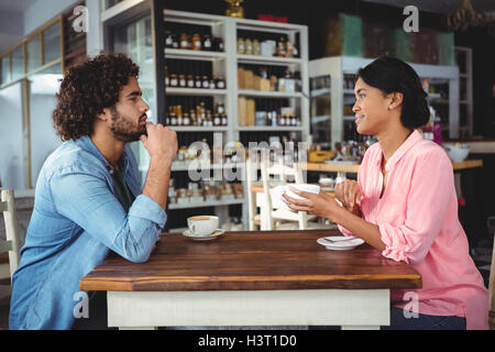 Couple interacting with each other while having coffee Stock Photo