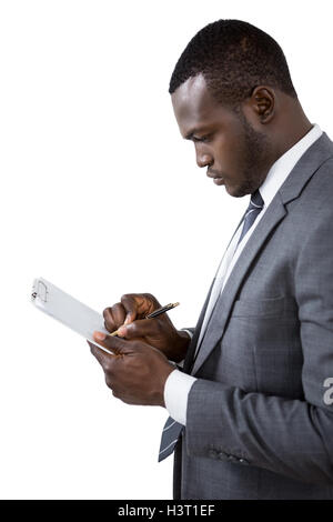 Businessman writing on clipboard Stock Photo