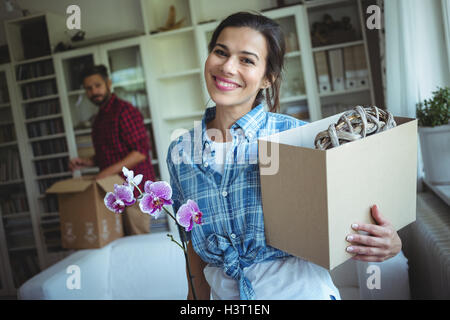 Happy couple unpacking cartons together Stock Photo