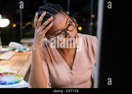 Businesswoman working on computer at her desk Stock Photo