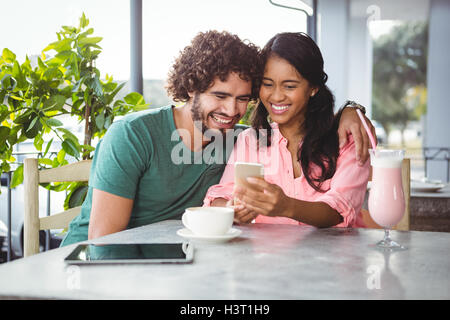 Couple looking at mobile phone Stock Photo