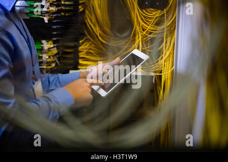 Technician using digital tablet Stock Photo