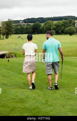 Couple walking on a golf course Stock Photo
