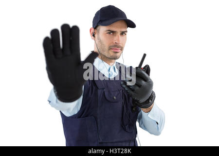 Confident security officer making stop gesture Stock Photo