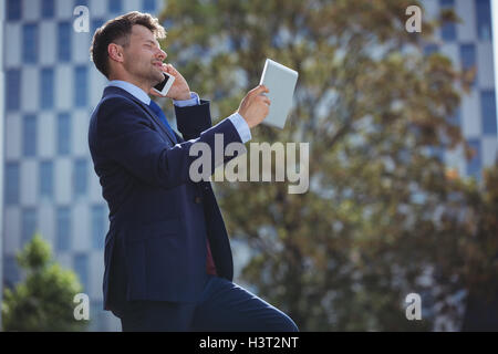 Businessman talking on mobile phone Stock Photo