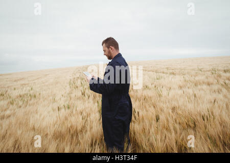 Farmer using digital tablet in the field Stock Photo
