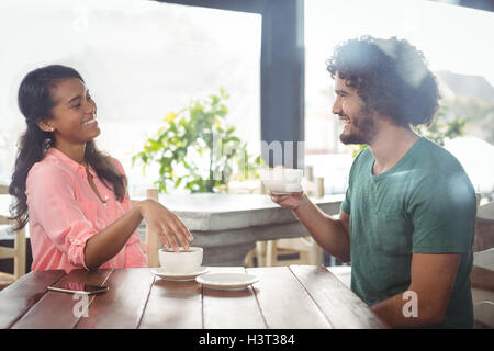 Couple interacting with each other while having coffee Stock Photo