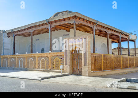 The small medieval Oybinok mosque with the shady wooden terrace located in the old town of Bukhara, Uzbekistan. Stock Photo