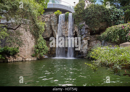 Artificial waterfall and pond at the Hong Kong Park in Hong Kong, China. Stock Photo