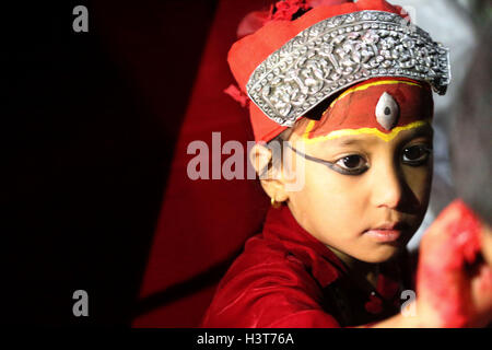 Kathmandu, Nepal. 11th Oct, 2016. Living Goddess Kumari of Kilagal offers Tika to local people during Khadga Jatra(Sword Procession) on Dashami, the tenth day of Dashain festival in Kathmandu, Nepal. Newar community of valley take out a victory parade of sword procession from different places. © Archana Shrestha/Pacific Press/Alamy Live News Stock Photo