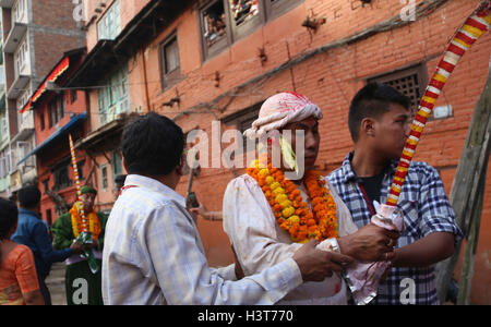 Kathmandu, Nepal. 11th Oct, 2016. Devotees dressed up as deity carrying sword participate in Khadga Jatra(Sword Procession) on Dashami, the tenth day of Dashain festival in Kathmandu, Nepal. Newar community of valley take out a victory parade of sword procession from different places. © Archana Shrestha/Pacific Press/Alamy Live News Stock Photo