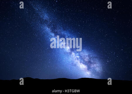 Milky Way. Night colorful landscape with stars. Starry sky with hills at summer. Space background with galaxy at mountains Stock Photo