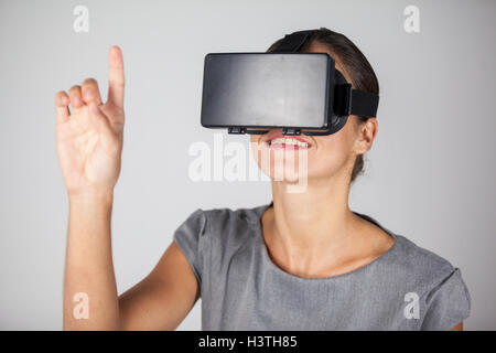 Woman using virtual reality headset Stock Photo