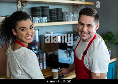 Smiling waitress and waiter in cafe Stock Photo