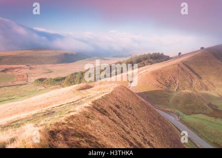 Mist surrounding Rushup Edge and The Great Ridge in the Peak District at dawn. Stock Photo