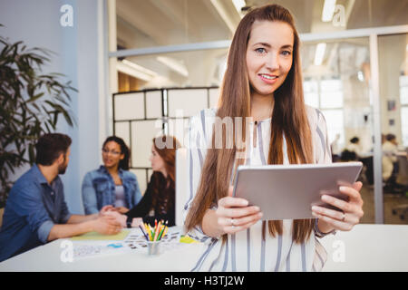 Attractive businesswoman using digital tablet in meeting room Stock Photo