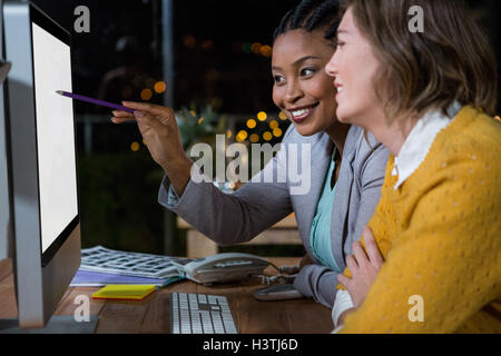 Businesswomen working on computer at their desk Stock Photo