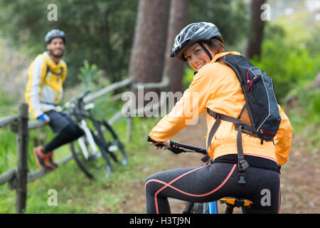 Female biker with mountain bike in countryside Stock Photo