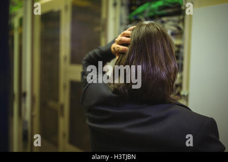 Stressed technician working on server maintenance Stock Photo