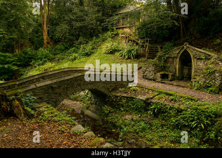 The bridge crossing the Cyflymen stream leading to the font and summerhouse in the gardens at Plas Newydd Llangollen Stock Photo