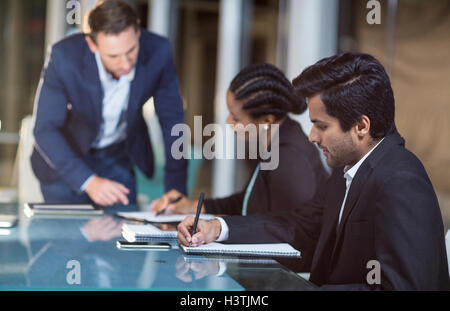 Businessman interacting with coworkers in a meeting in the conference room Stock Photo