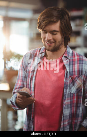 Smiling man using mobile phone Stock Photo