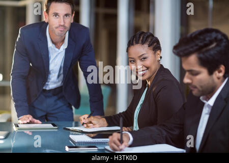 Businessman and businesswoman sitting in a meeting in the conference room Stock Photo