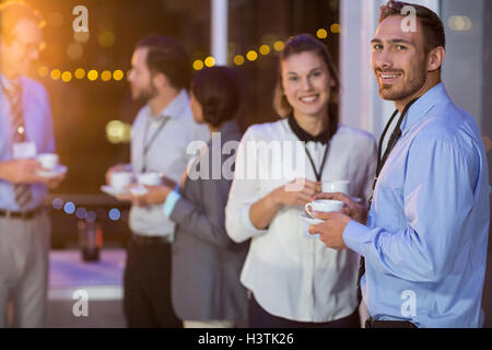 Businesspeople having coffee during break Stock Photo
