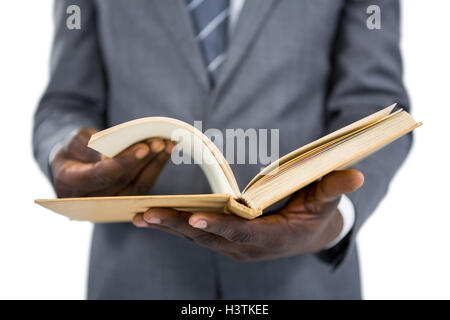 Mid section of businessman flipping the pages of a book Stock Photo